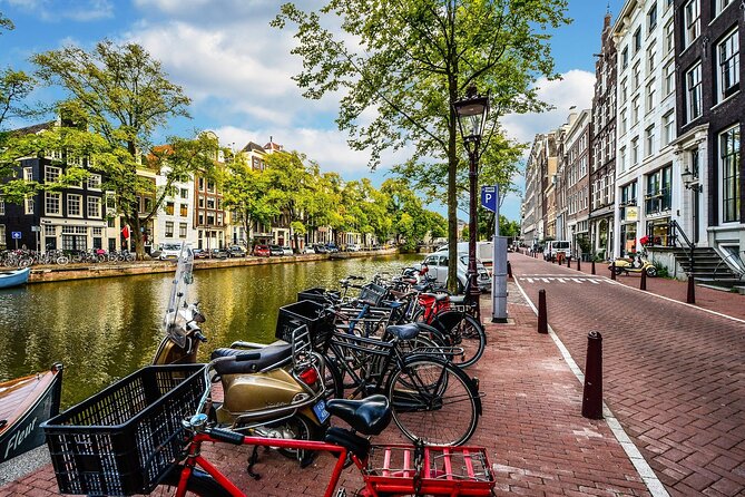 Amsterdam Day Trip from Brussels With Cheese, Clogs and Windmills - Arriving in Amsterdam: Dam Square, Royal Palace Exterior, and Fast Orientation
