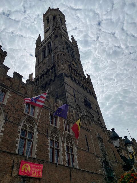 Bruges Guided Walking Tour: Stories, Mysteries and People - First steps in Market Square with a yellow-umbrella guide